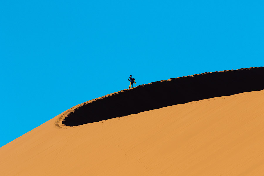 A couple walking up a dune